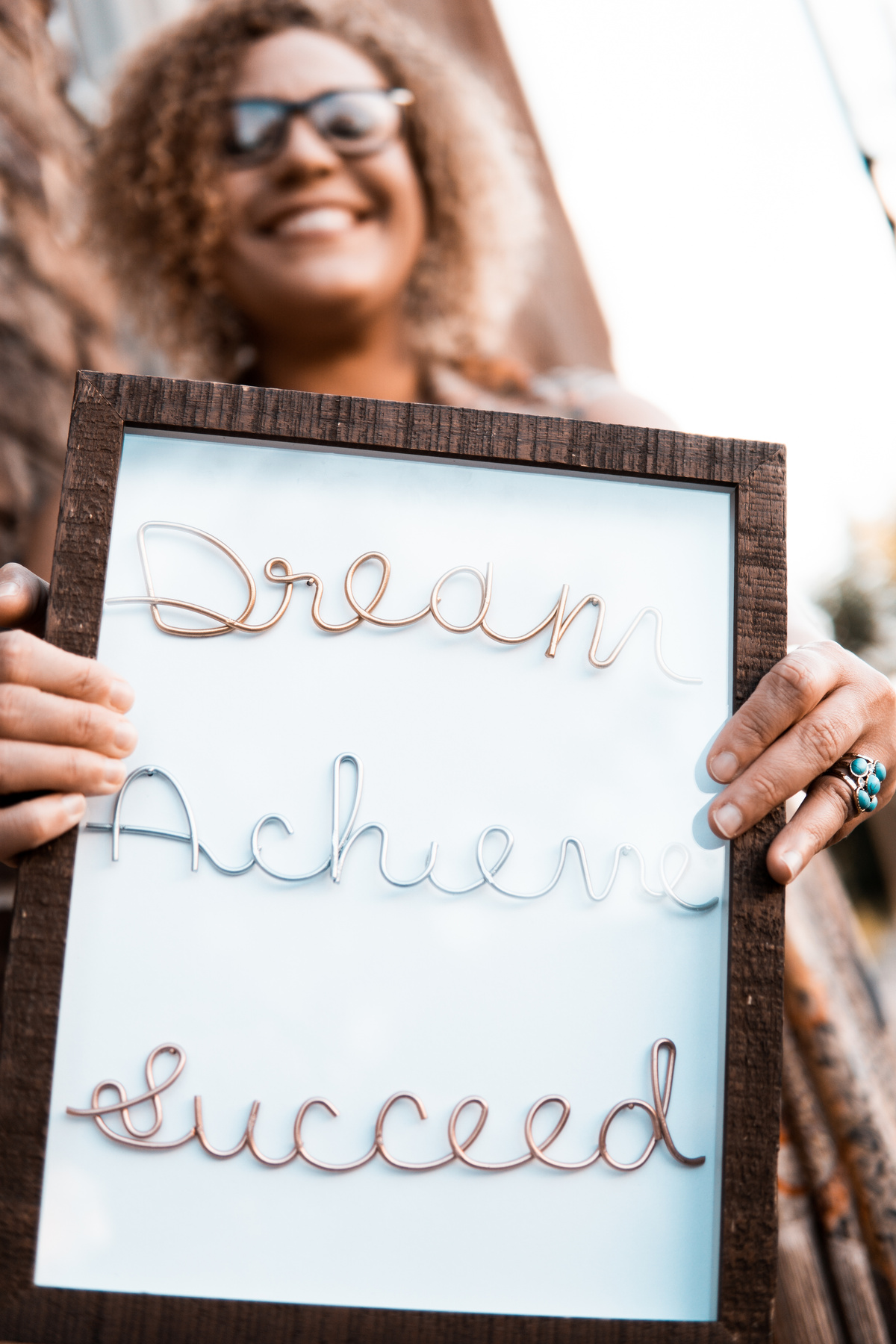 Woman Holding Brown Wooden Frame With Dream Achieve Succeed